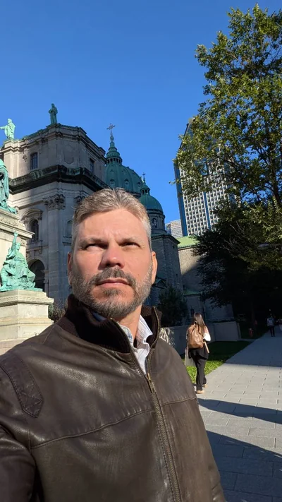 Felipe in downtown Montreal, Quebec, with historic architecture behind him.